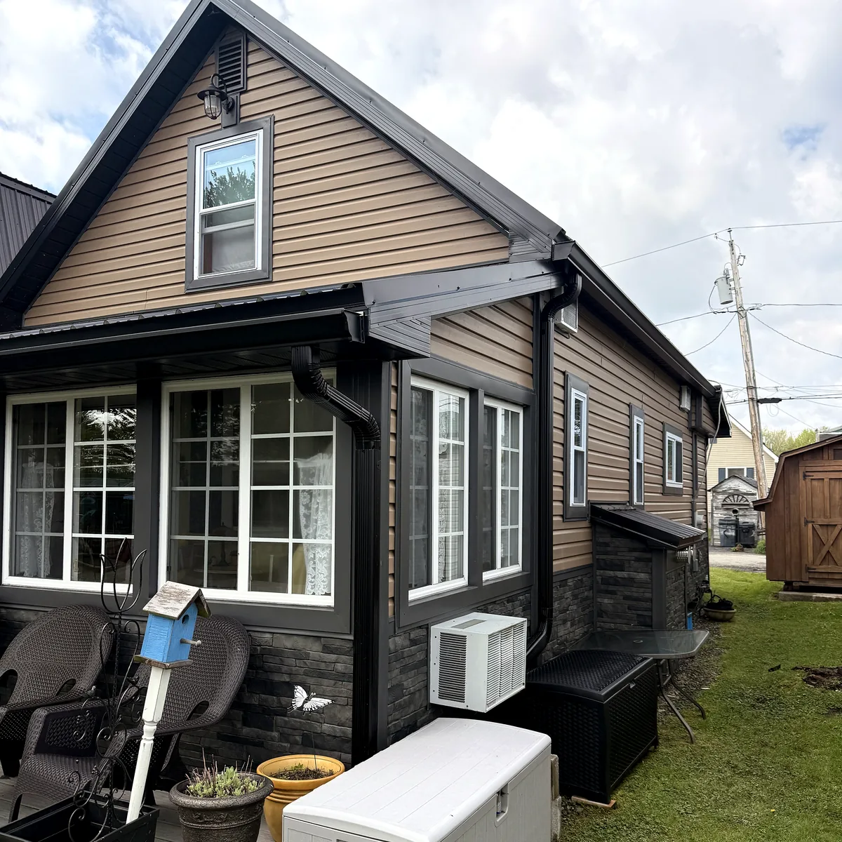 Front gable project with siding, windows, porch, and finished trim.